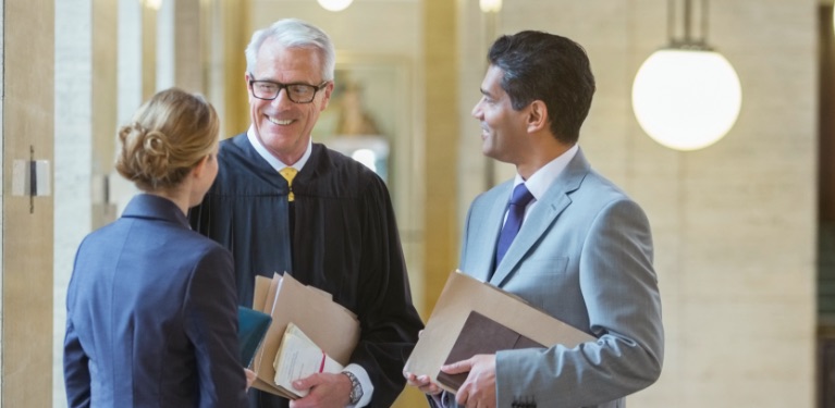 three people talking in a law building