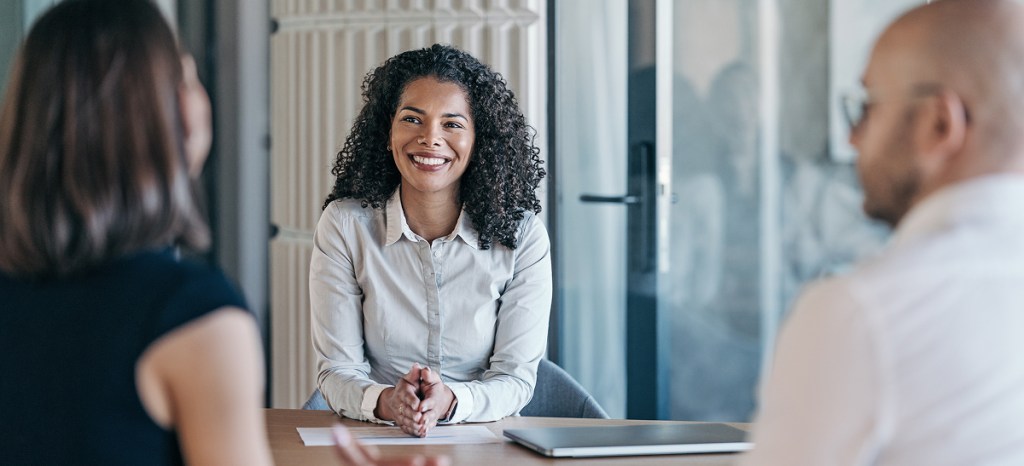 professional woman facing two people at table