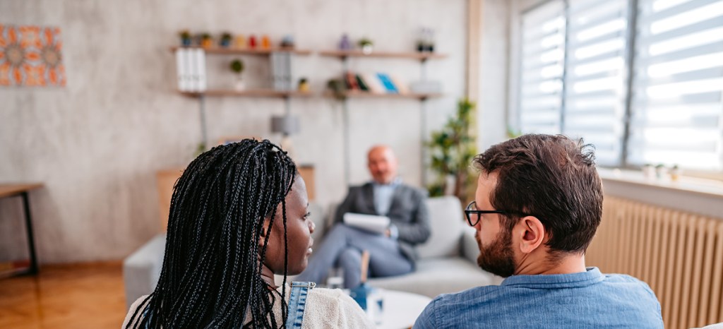 Couple speaking to each other in couples counseling